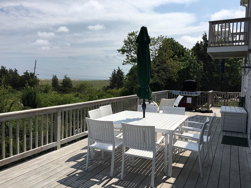 Right View Image Of Dining Table With Chairs On A Terrace In Our 3 Boardwalk Cape Cod Vacation Rental